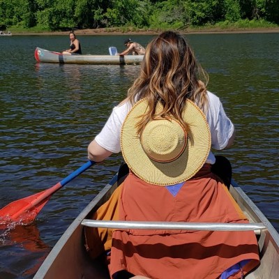 a person sitting on a boat in a body of water