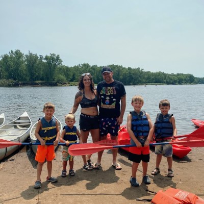 a group of people standing next to a body of water