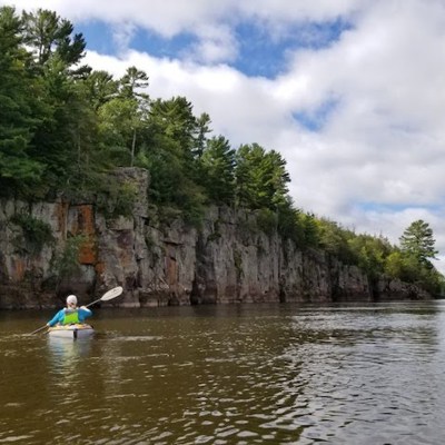 a man riding on the back of a boat in the water