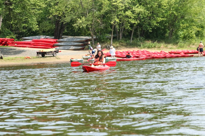 a group of people in a small boat in a body of water