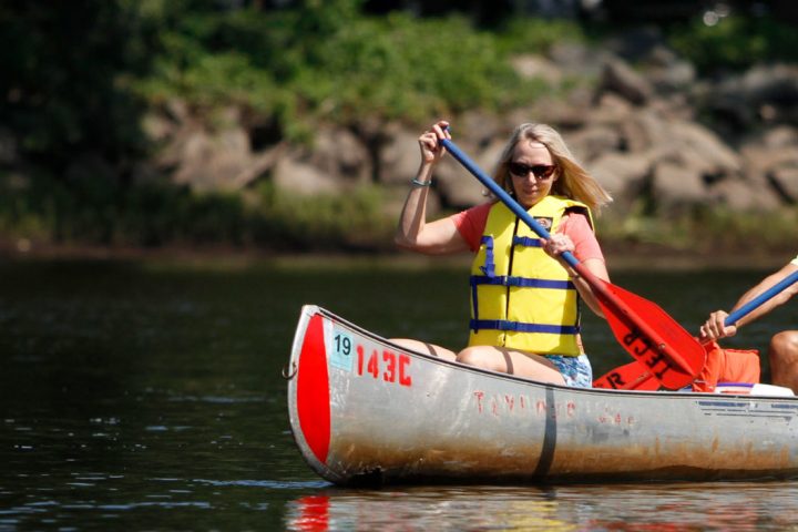 a person riding on the back of a boat
