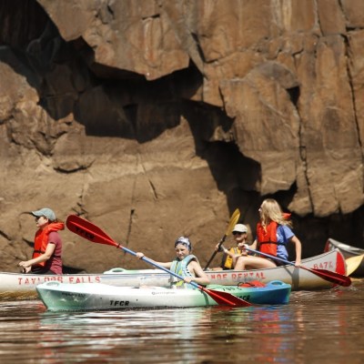 a group of people riding on the back of a boat