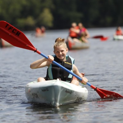 a man riding on the back of a boat in the water