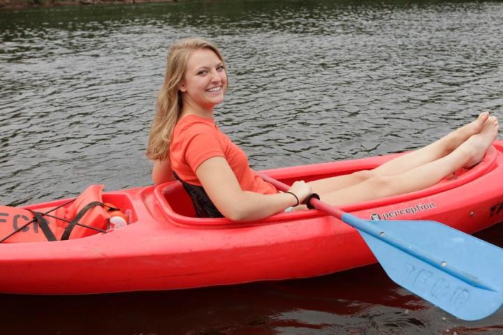 a person sitting on a boat in a body of water