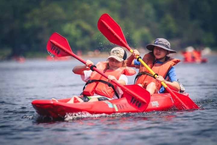 a person riding on the back of a boat in a body of water
