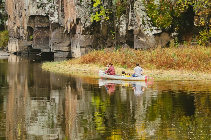 a small pond in front of a body of water