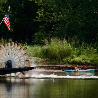a person driving a boat in the water