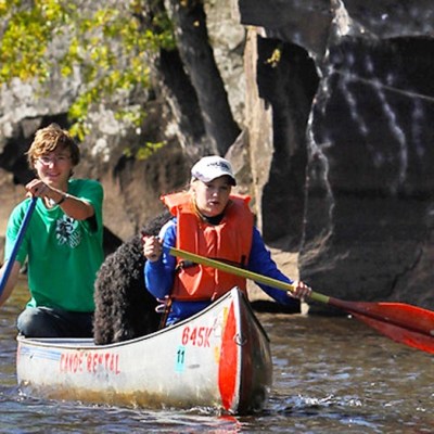 a person riding on the back of a boat in the water
