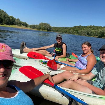 a group of people sitting in a boat on a body of water