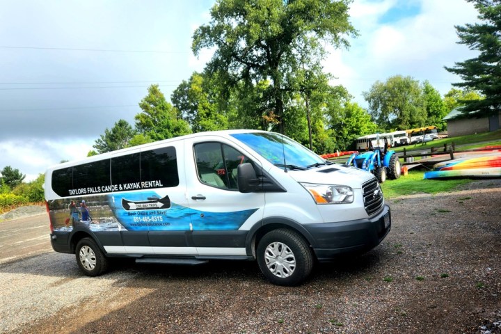 a shuttle van parked in a parking lot