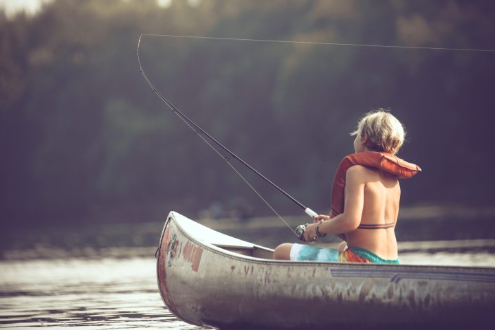 a person riding on the back of a boat